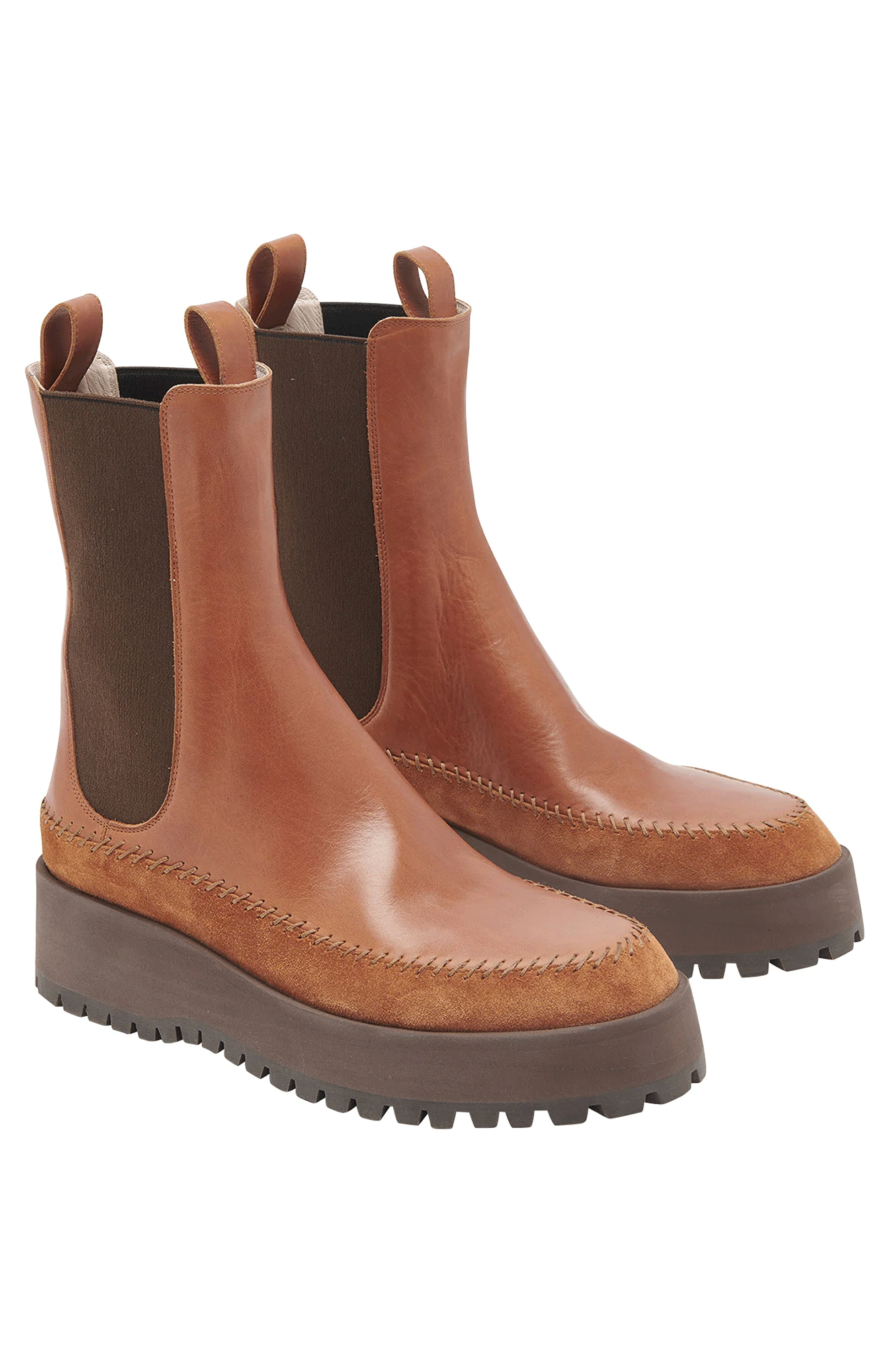 The Jodie Chelsea Lug Sole from Ulla Johnson features a combination of premium leather and suede, resting on a chunky lug sole. An eye-catching brown hue with classic elastic side panels and whipstitched trims make this stylish boot a must-have this season.