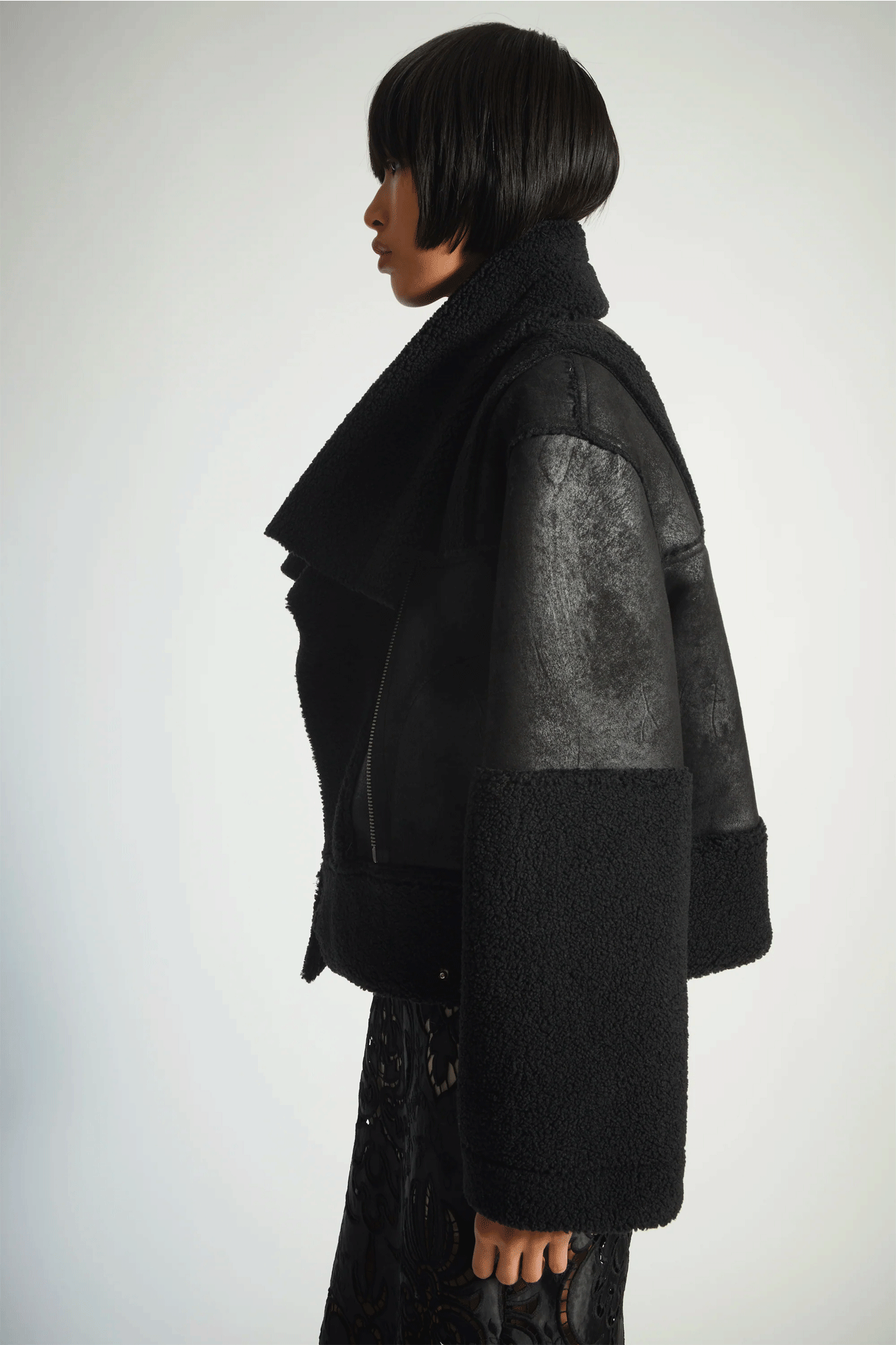 The Marlise Faux Shearling Moto Jacket from Saint Art is a perfect blend of style, practicality, and comfort. Expertly crafted from vegan leather, the jacket offers a touch of luxury without compromising your values. The classic black color ensures timeless sophistication, allowing you to express your personal style.