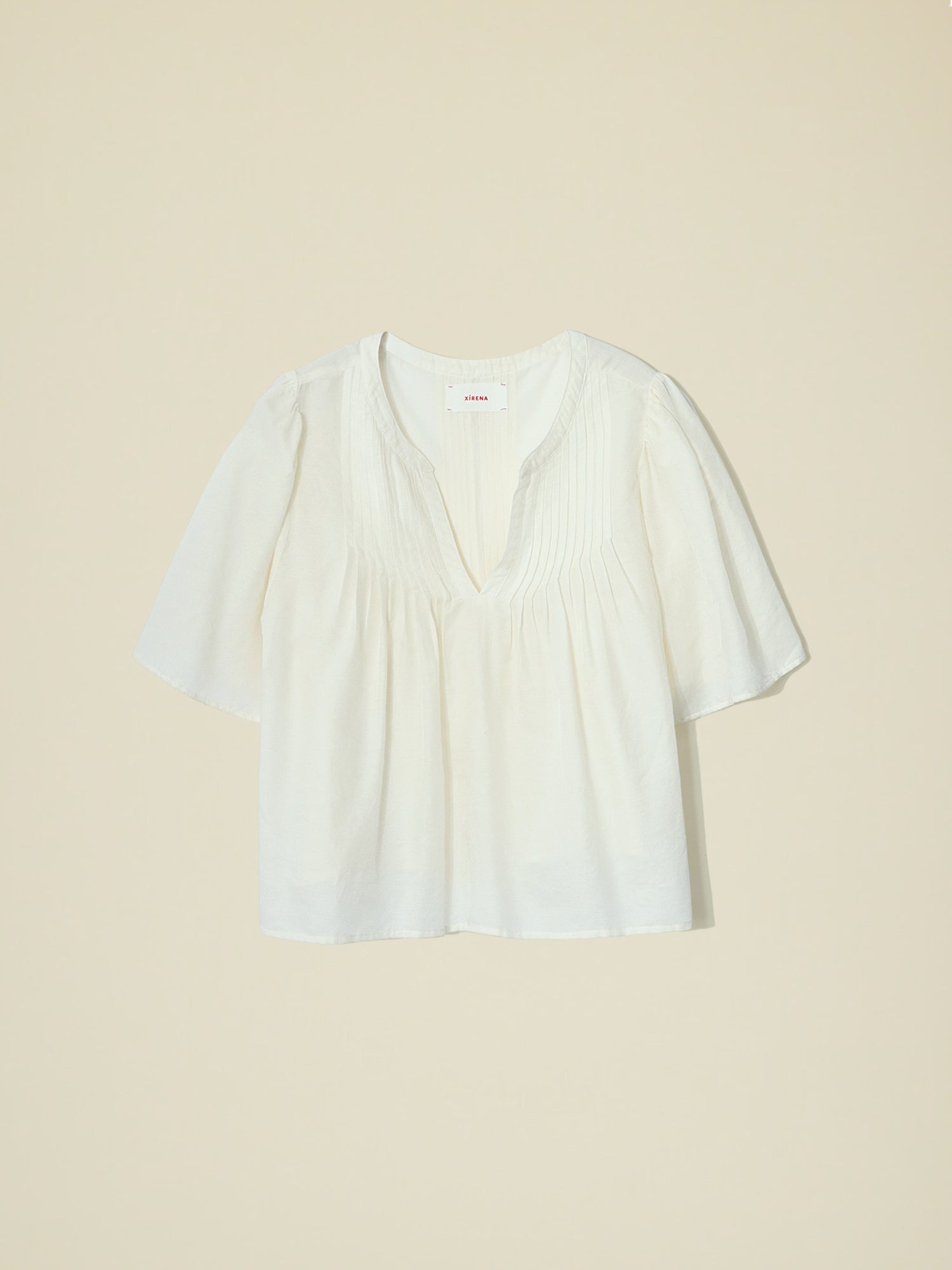 The Micah Top from Xirena is a luxurious, medium-weight, cotton-silk twill blend garment with an open-front, stand collar,