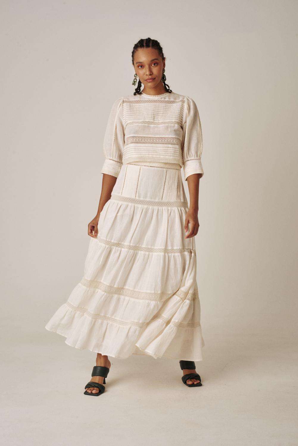 Carolina K Skirt: The Catalina Skirt from Carolina K has a high-waisted and banded waist. It is tiered with an invisible side seam zipper and straight hem. It is maxi length and flowy. 