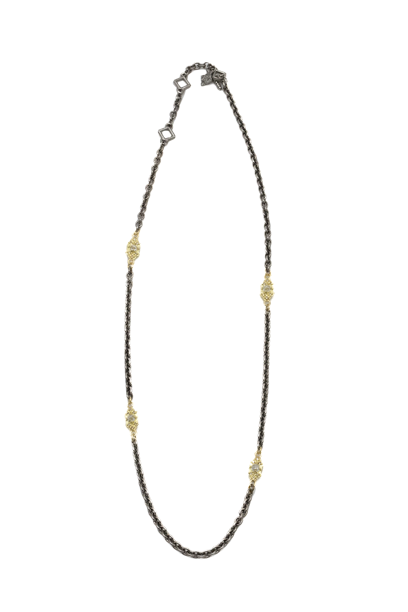 This Gold Scroll Link Necklace from Armenta is crafted with 18k yellow gold and sterling silver using an 18" grey cable chain with carved scroll stations set with white sapphires and champagne diamonds. The intricate design and combination of metals bring a touch of Old World elegance to any outfit.
