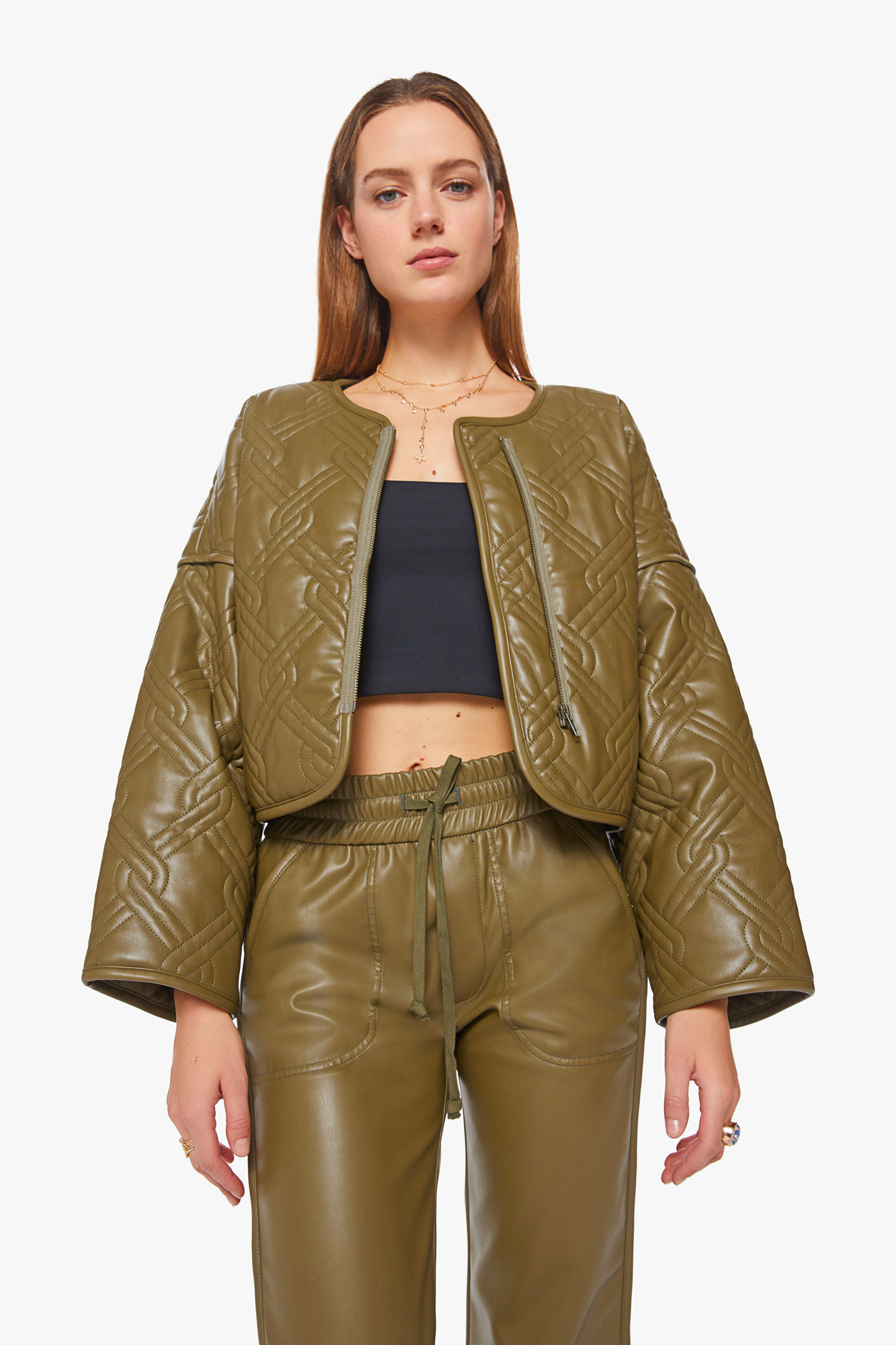 Elevate your wardrobe with The Underliner Jacket from Mother. Crafted from a luxurious faux leather fabric, this boxy jacket features drop shoulders, extra-wide long sleeves, and a cropped hem for a modern look. 