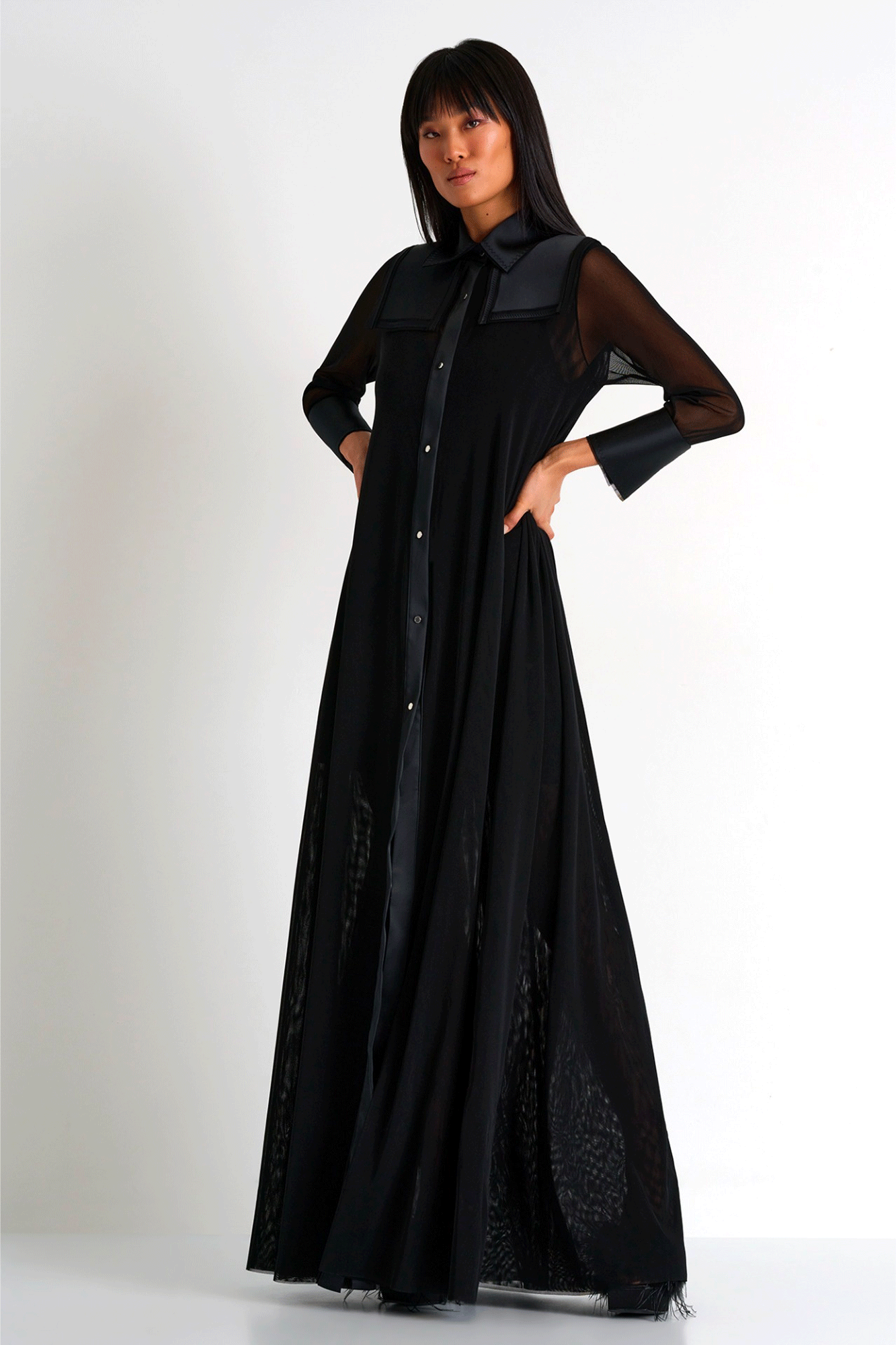 Modern elegance comes alive in the Helena Maxi Mesh Dress from Shan. Its classic maxi shirt dress silhouette is designed with long mesh sleeves and satin French cuffs for an elevated, contemporary look. The golden front button closure and flare fit make for a graceful movement with every step. An essential piece for any wardrobe.