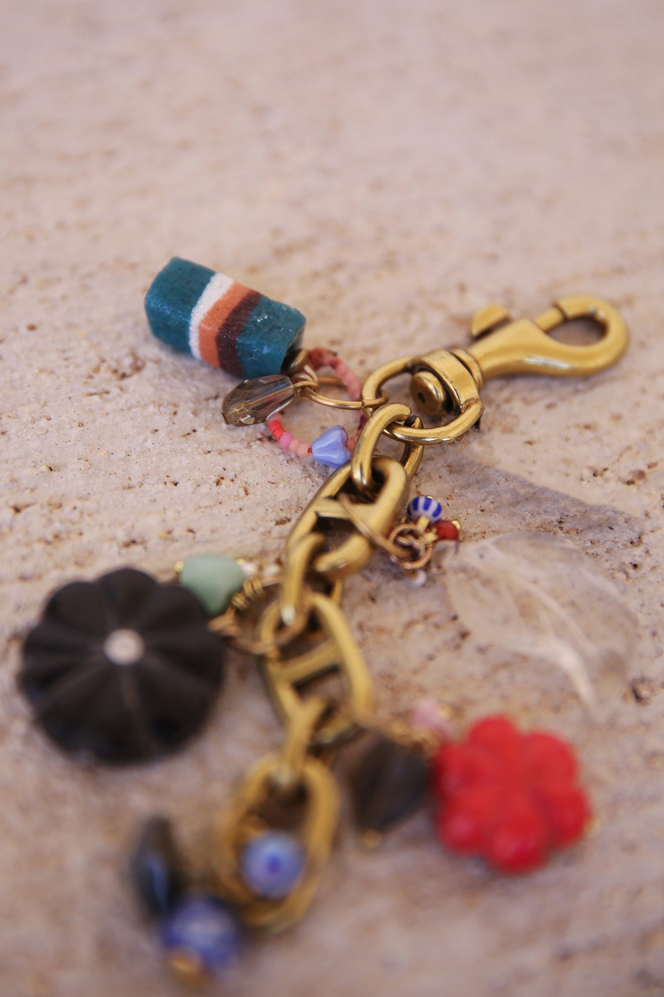 Brass Bag Charm w/ Quartz Leaf, Red Magnesite Flower, Horn Flower, Jade Heart, Czech Glass, + Ghanaian Sandcast Bead