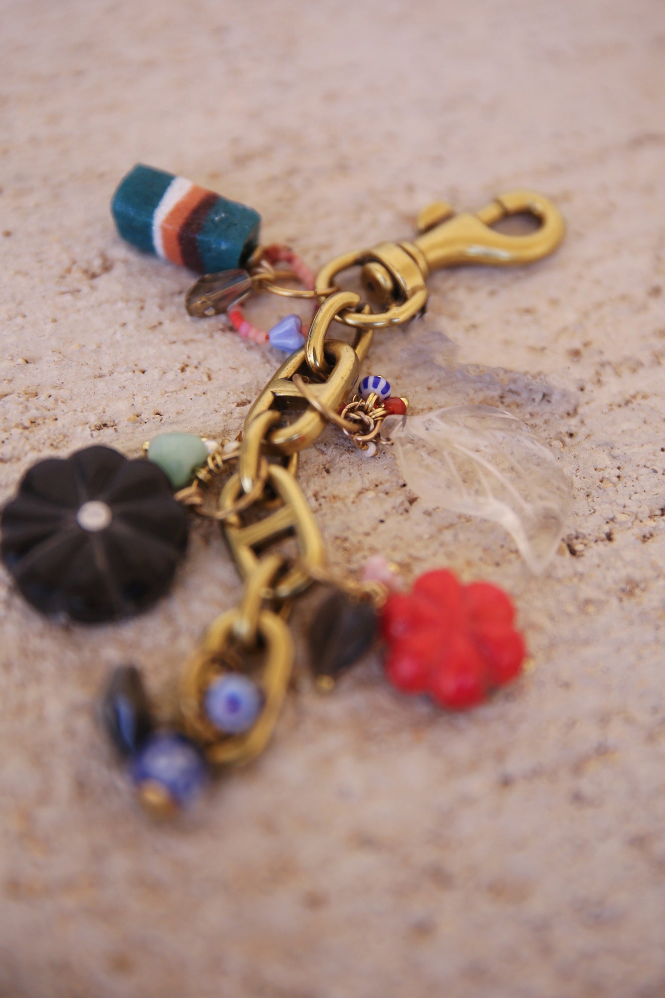 Brass Bag Charm w/ Quartz Leaf, Red Magnesite Flower, Horn Flower, Jade Heart, Czech Glass, + Ghanaian Sandcast Bead