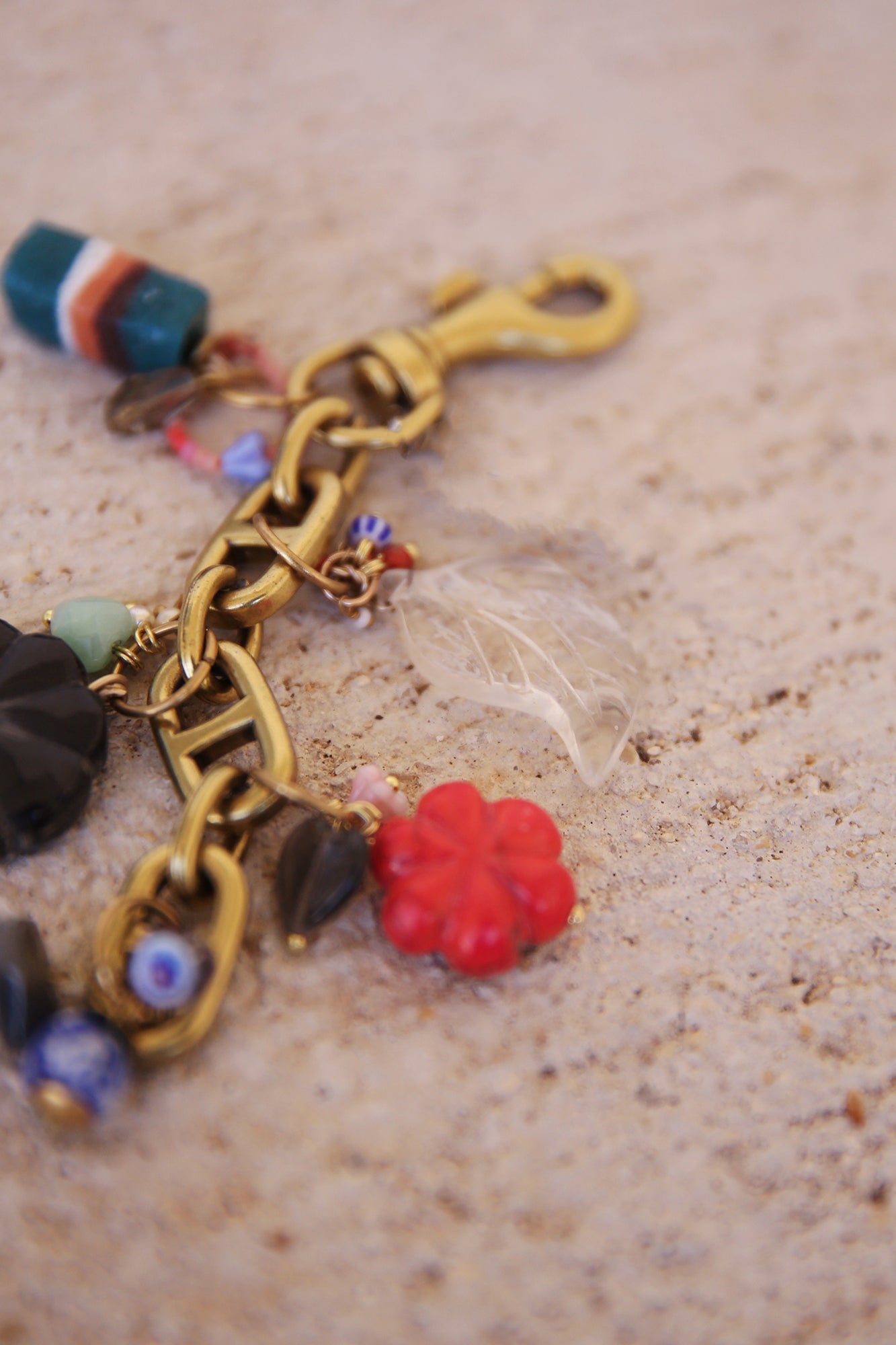 Brass Bag Charm w/ Quartz Leaf, Red Magnesite Flower, Horn Flower, Jade Heart, Czech Glass, + Ghanaian Sandcast Bead