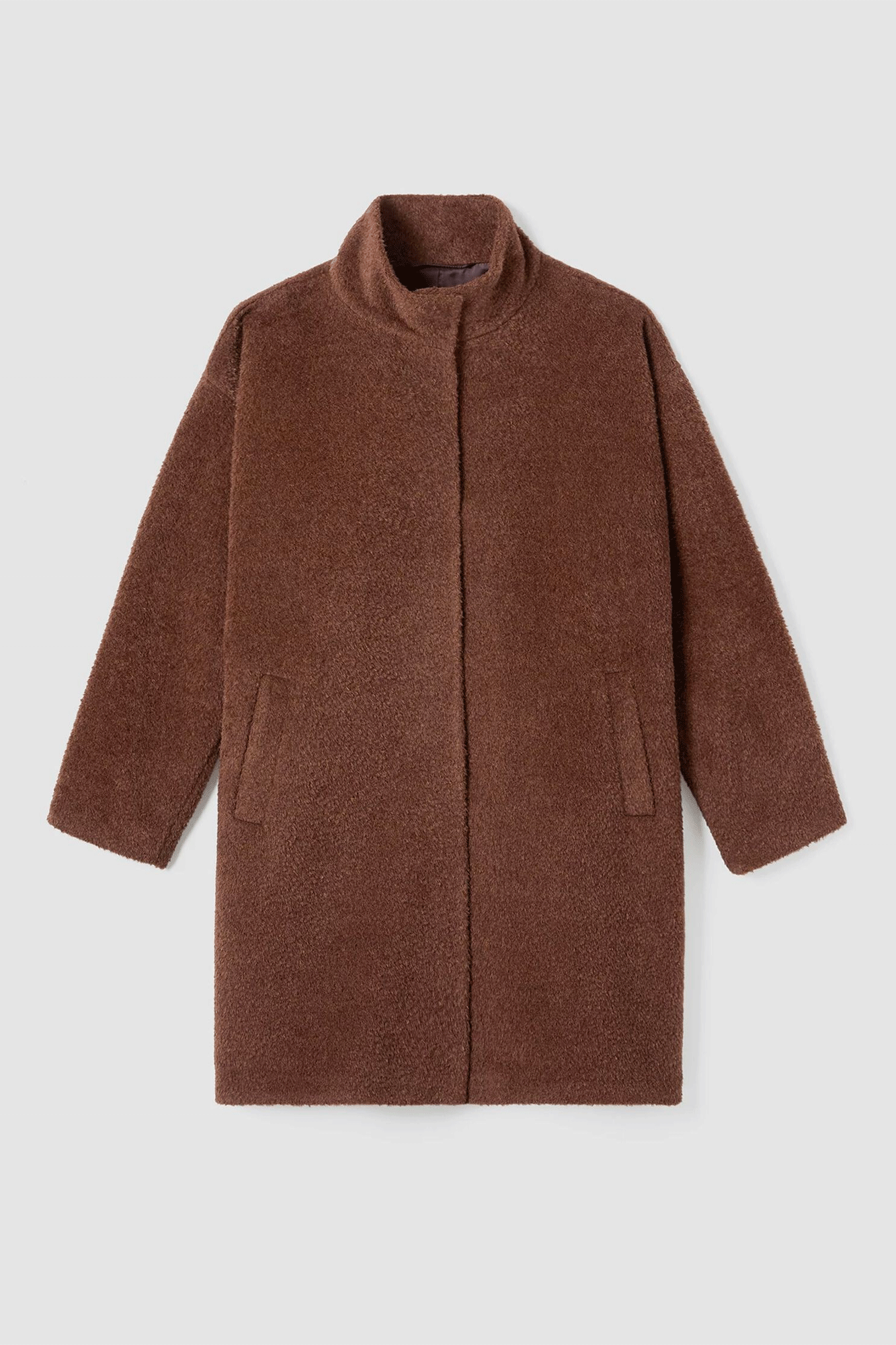 This Stand Collar Coat is a luxurious blend of warmth and lightweight fabric. Crafted with alpaca shearing, it will keep you warm without weighing you down. A stand collar and snap closure give an elegant finish to this timeless piece.