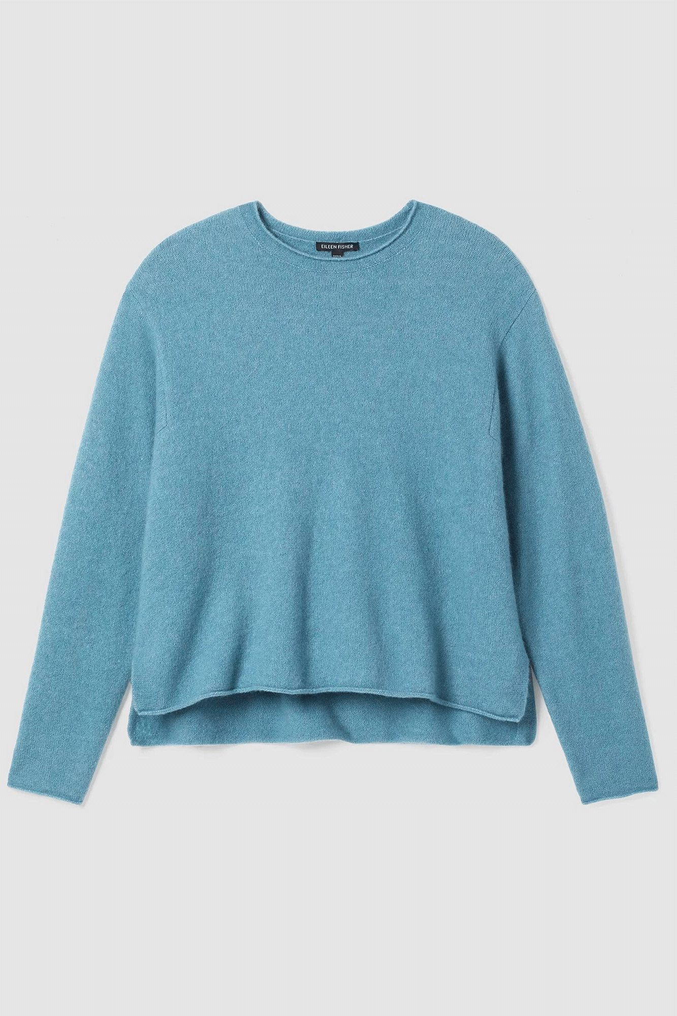 This Crew Neck Box Top from Eileen Fisher is designed for ultimate comfort without compromising style. Crafted from a luxurious blend of cashmere and silk, it has a simple silhouette with soft texture and subtle side slits. Enjoy all-season coziness and elegance.