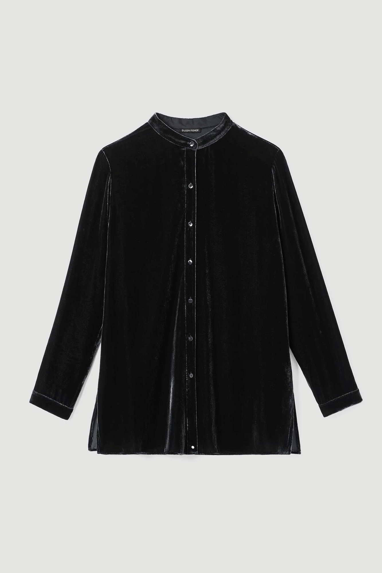 This Mandarin Collar Long Shirt from Eileen Fisher brings timeless elegance to your wardrobe. Crafted from a luxurious blend of velvet and silk, it features a band collar with shirring at the back and side slits for a comfortable fit. Perfect for making a statement this season.