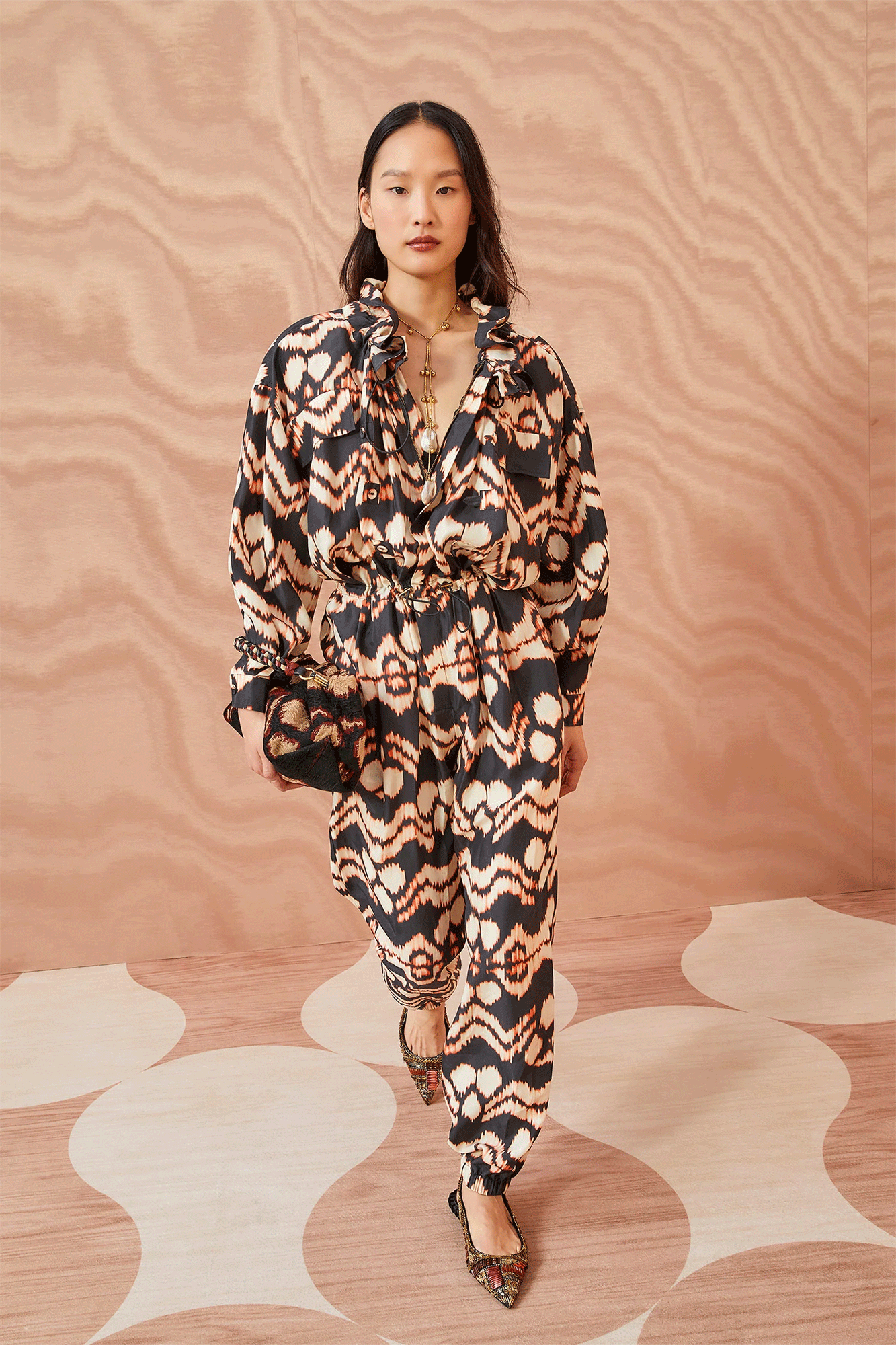 The Aida Jumpsuit from Ulla Johnson is designed with statement-making details in mind, from the printed silk taffeta in an ikat-inspired graphic stripe to the peony-inspired ruffled collar, buttoned cuffs, and elastic nipped-in waist adorned with a bungee cord.