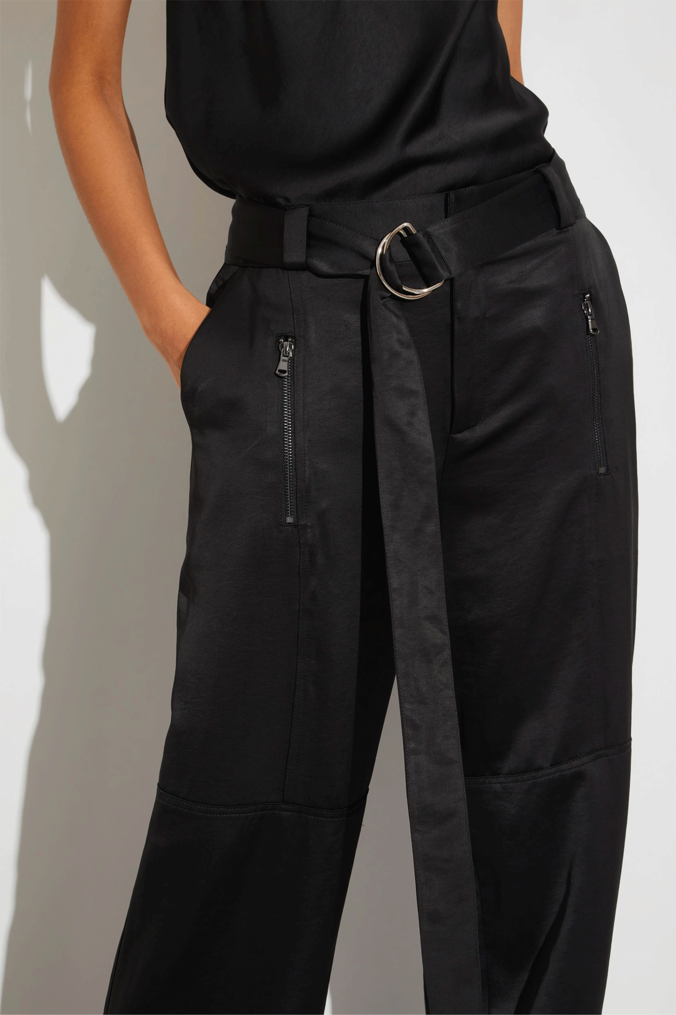The Courtney Mid-Rise Charmeuse Pant from Saint Art offers a sophisticated look and feel. Made of wrinkle-proof and machine-washable material, the heavy-weight charmeuse cargo pant features oversized pocket and zipper detailing, belt loops and a detachable D-ring tie belt. Zipper pockets at front and back complete this stylish design.