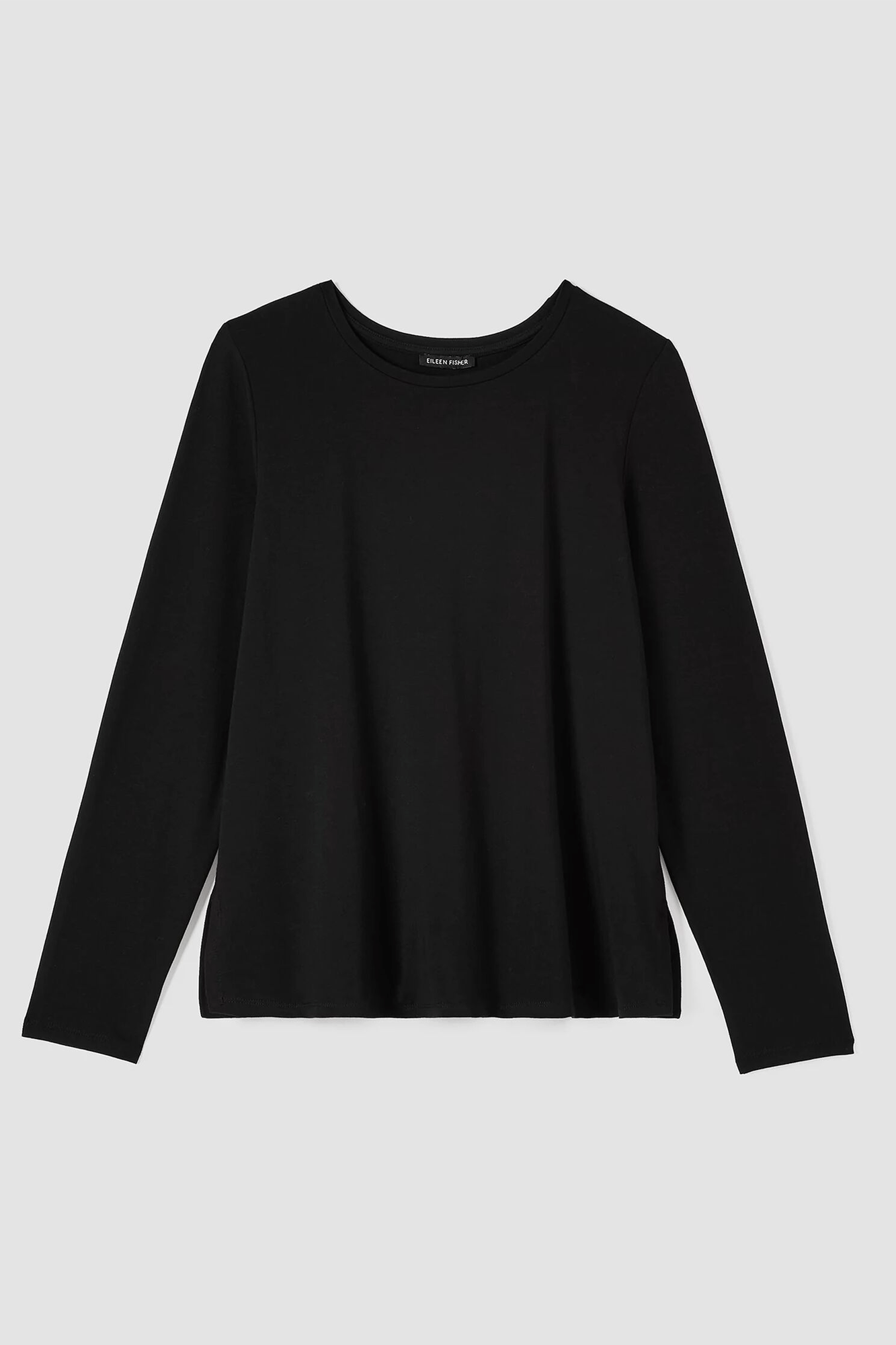 Easy and elevated. A simple top with a crew neck from Eileen Fisher features 4-inch side slits.