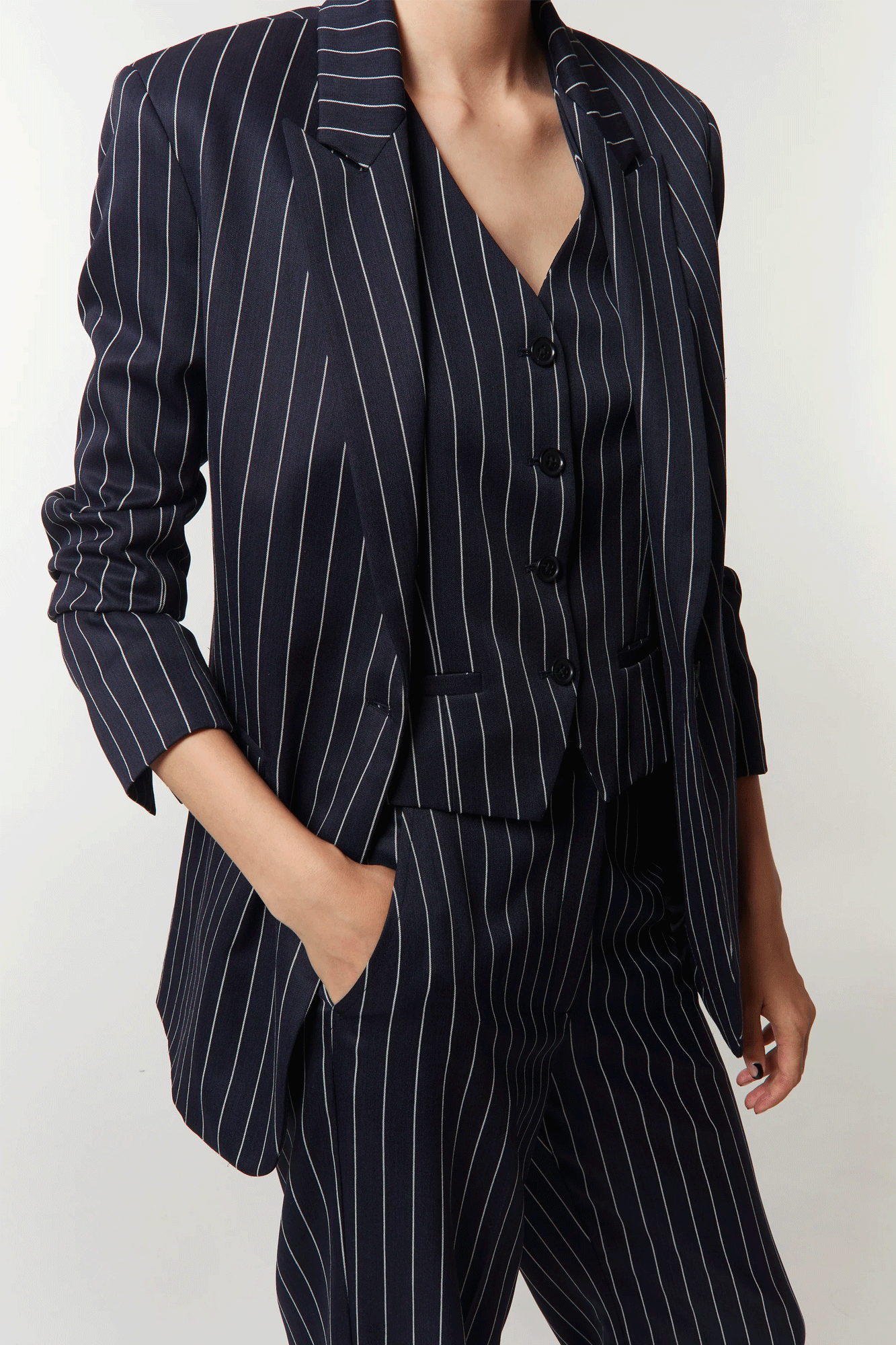 Flaunt timeless elegance with the Gia Pinstripe Blazer from Saint Art. 