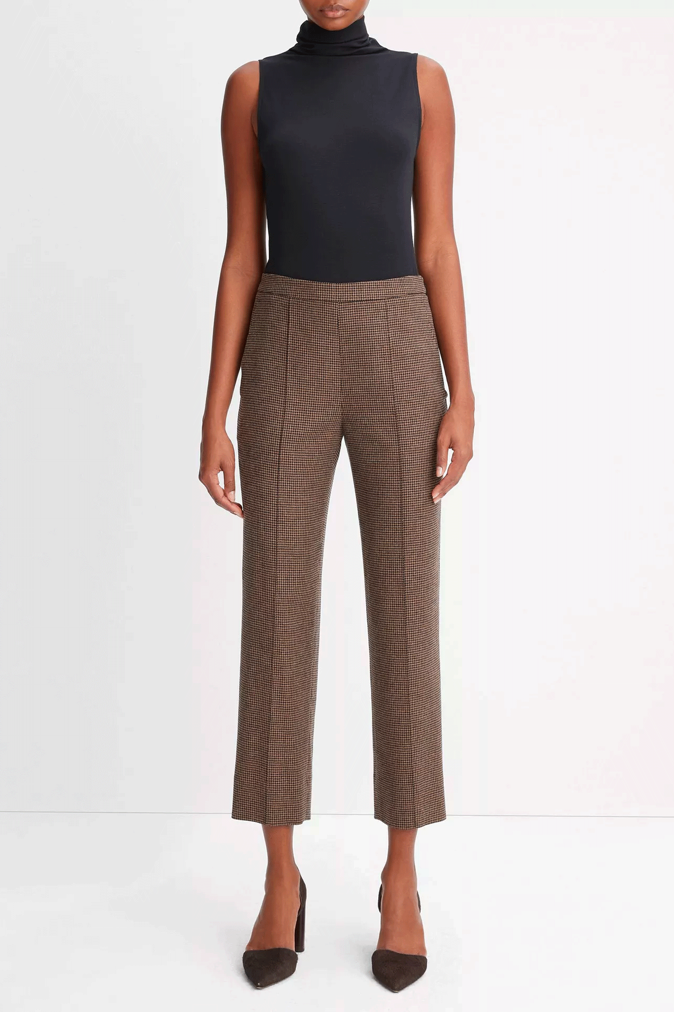 Elevate your style this season with our Houndstooth Mid Rise Pull On Pant. Crafted from a comfortable blend of materials, this pant features a mid-rise design with a discreet elastic back waistband. An all-over houndstooth motif and stitch-creased legs exude elegance and add a polished finish to any look.