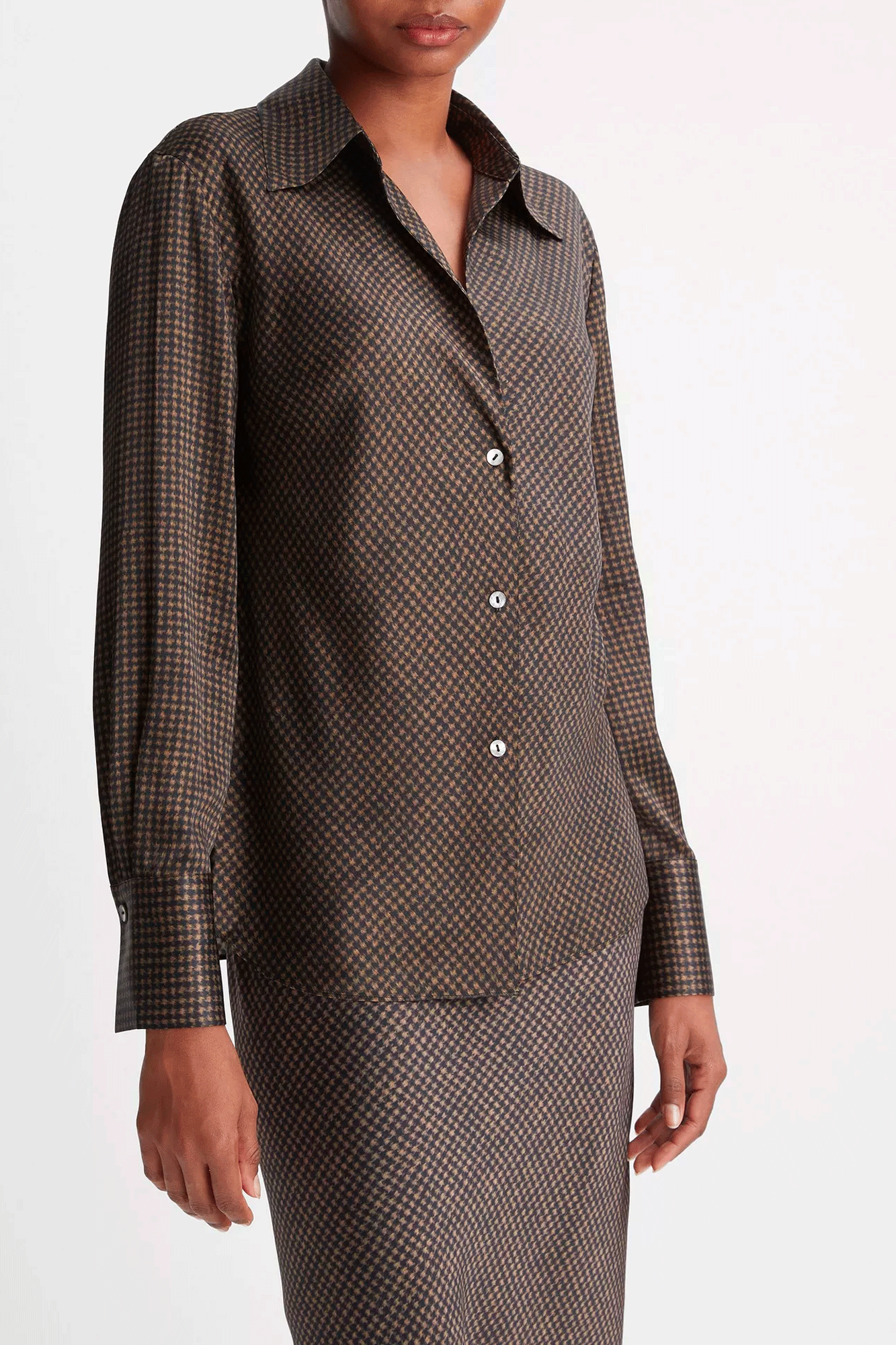 Flattering and fashionable, our Brushed Houndstooth Bias Long Sleeve Blouse from Vince is cut on the bias for a slim, contoured fit. The open-collared neckline and front cutaway add a stylish touch, while the Houndstooth pattern makes a bold statement. Wear with the matching skirt for a polished ensemble.